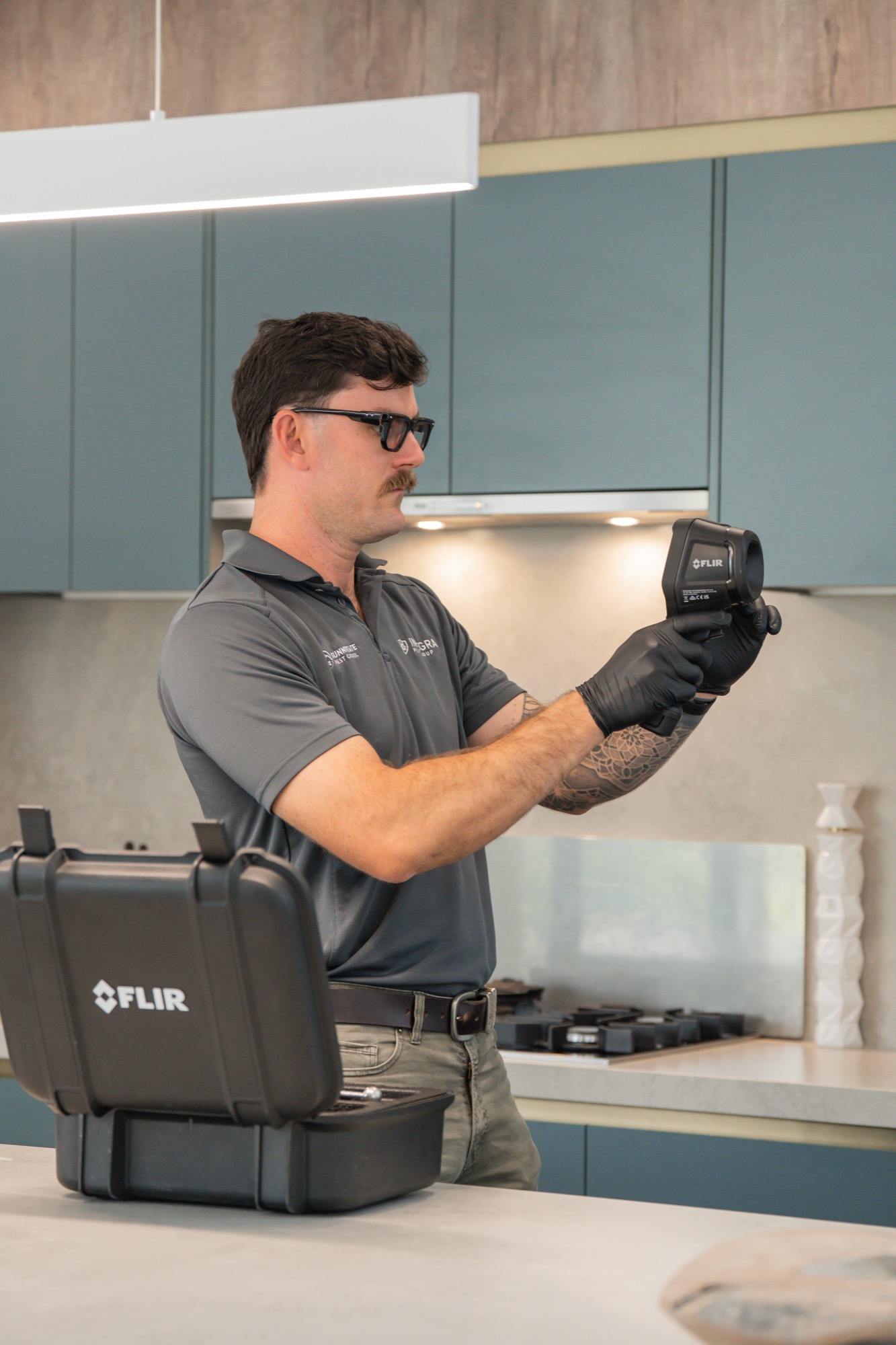 Sunnystate technician with FLIR thermal camera — used on every termite inspection