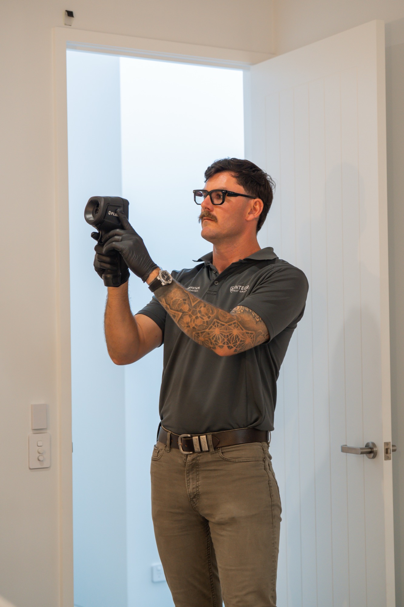 Sunnystate technician using FLIR thermal camera during inspection