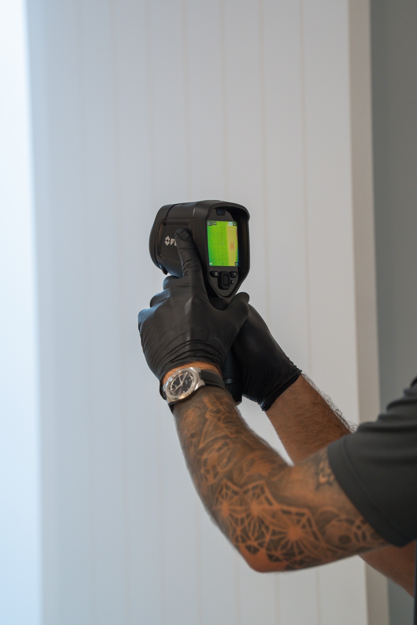 FLIR thermal camera scanning wall for termite heat signatures